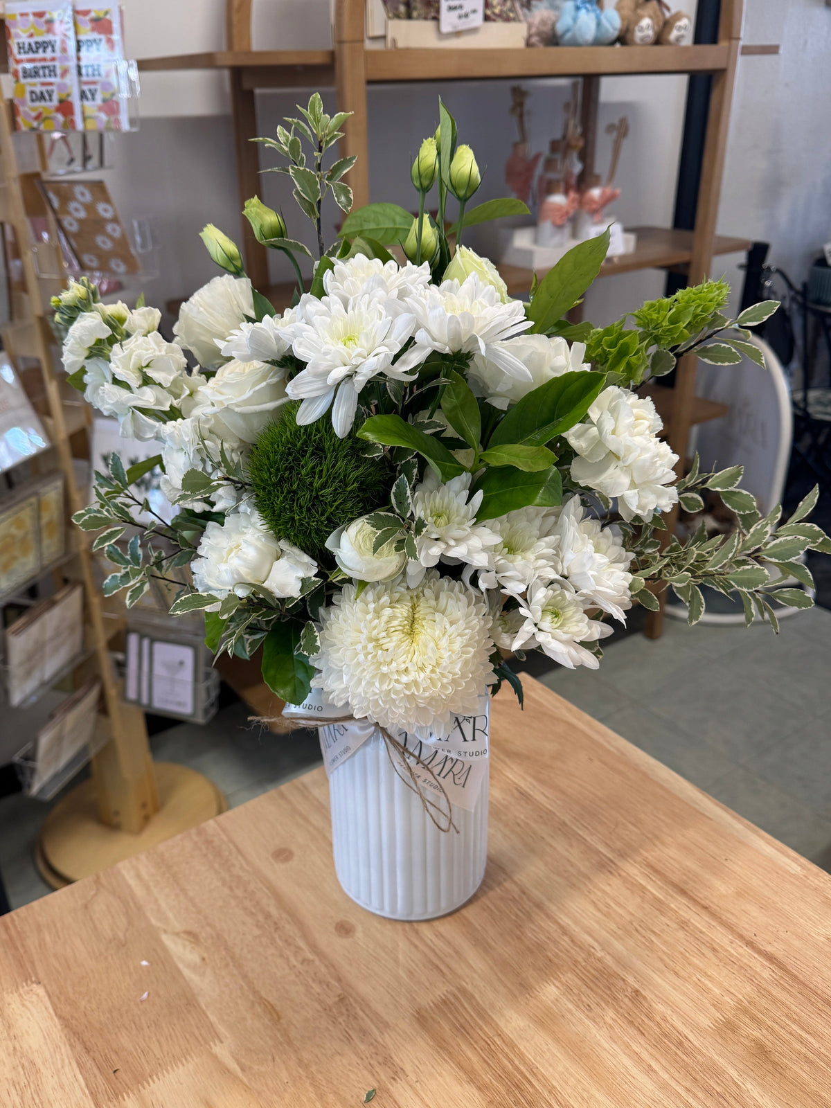 white & green vase arrangement